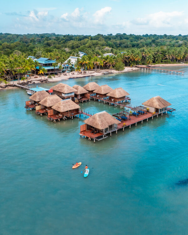 A group of houses on stilts in the middle of water.