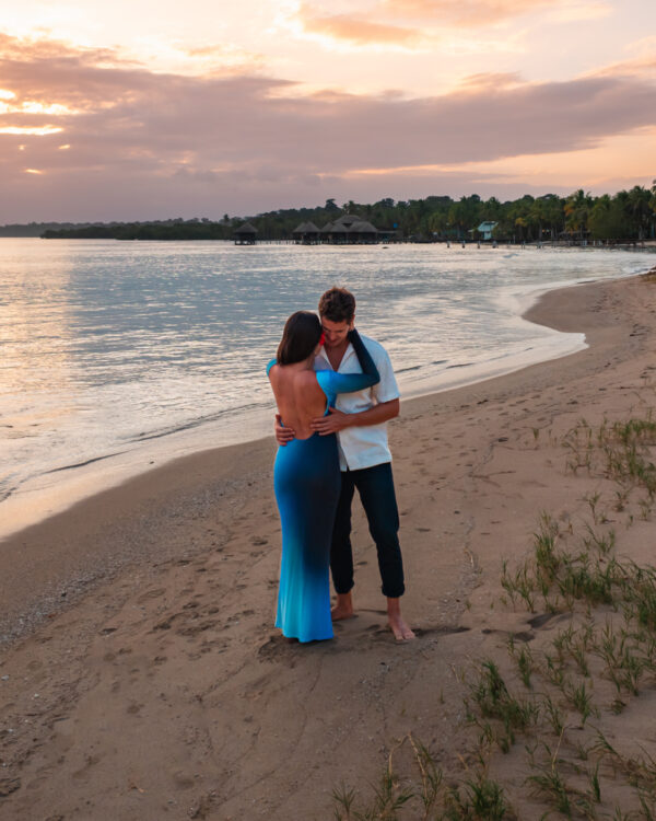 A man and woman standing on the beach