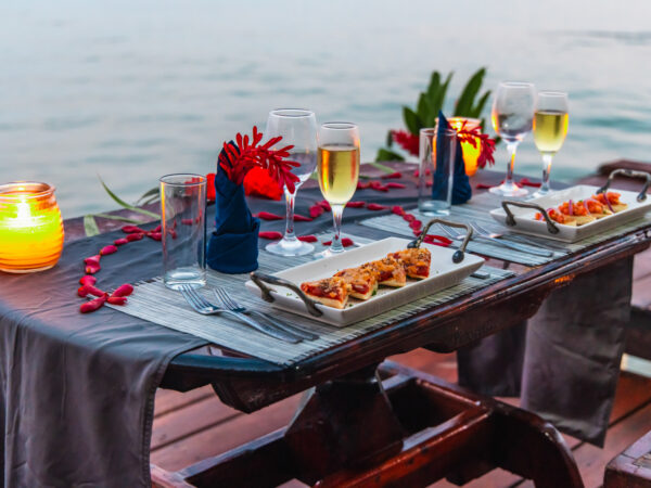 A table with plates and glasses of wine on it